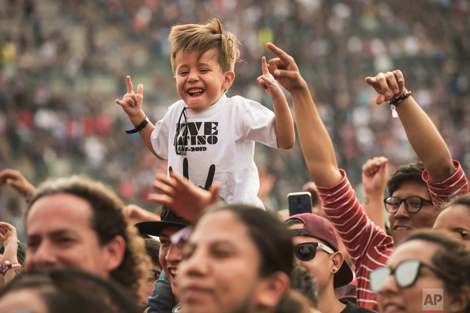 In this March 17, 2019 photo, a youth attends the Vive Latino music festival in Mexico City. The two-day rock festival is one of the most important and longest running of Mexico. (AP Photo/Christian Palma)