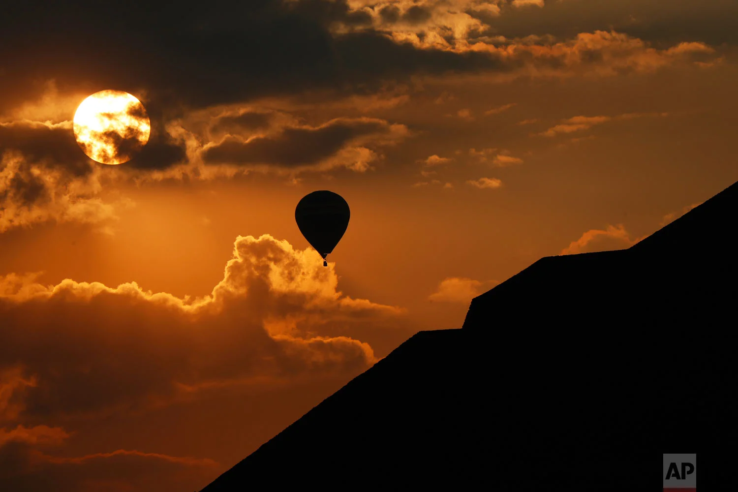 In this March 21, 2019 photo, a balloon flies near the Pyramid of the Sun in Teotihuacan, Mexico, on the Spring equinox. (AP Photo/Marco Ugarte)
