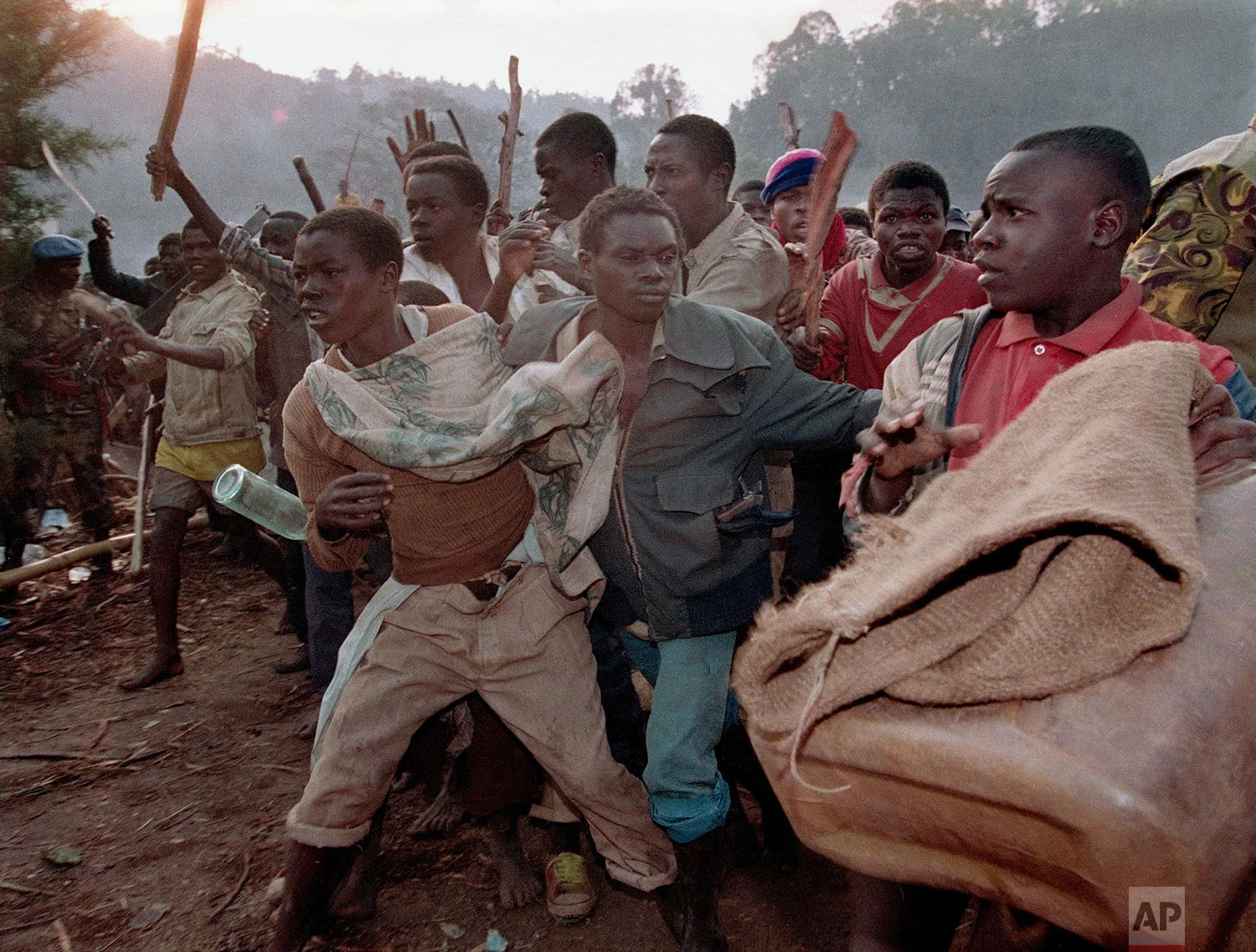 A crowd of Rwandan refugees angered by the closing of the border run to the border bridge to force their way into Zaire, Aug. 21, 1994. (AP Photo/Jean-Marc Bouju)