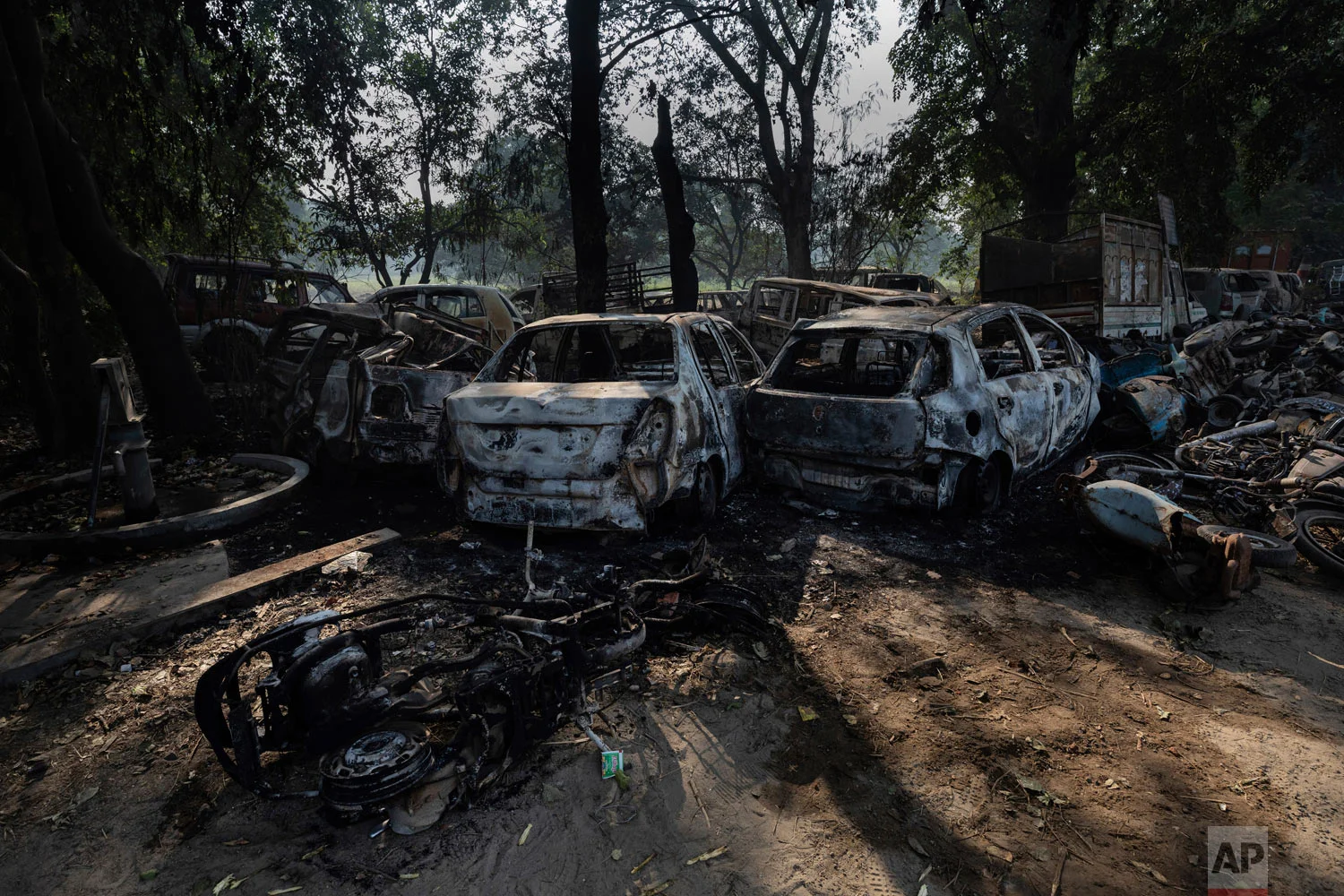 Vandalized cars and other vehicles sit in Chingarwathi, near Bulandshahr, in the northern Indian state of Uttar Pradesh, Dec. 4, 2018. (AP Photo/Bernat Armangue)