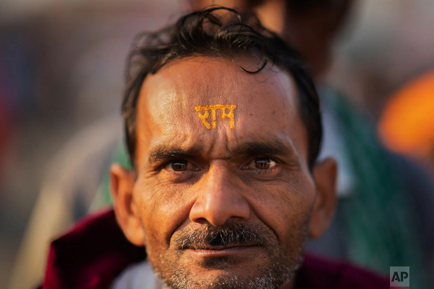 A Hindu hardline supporter wears the the name of the god Ram written on his forehead in Ayodhya, Uttar Pradesh, India, Nov. 25, 2018. (AP Photo/Bernat Armangue)
