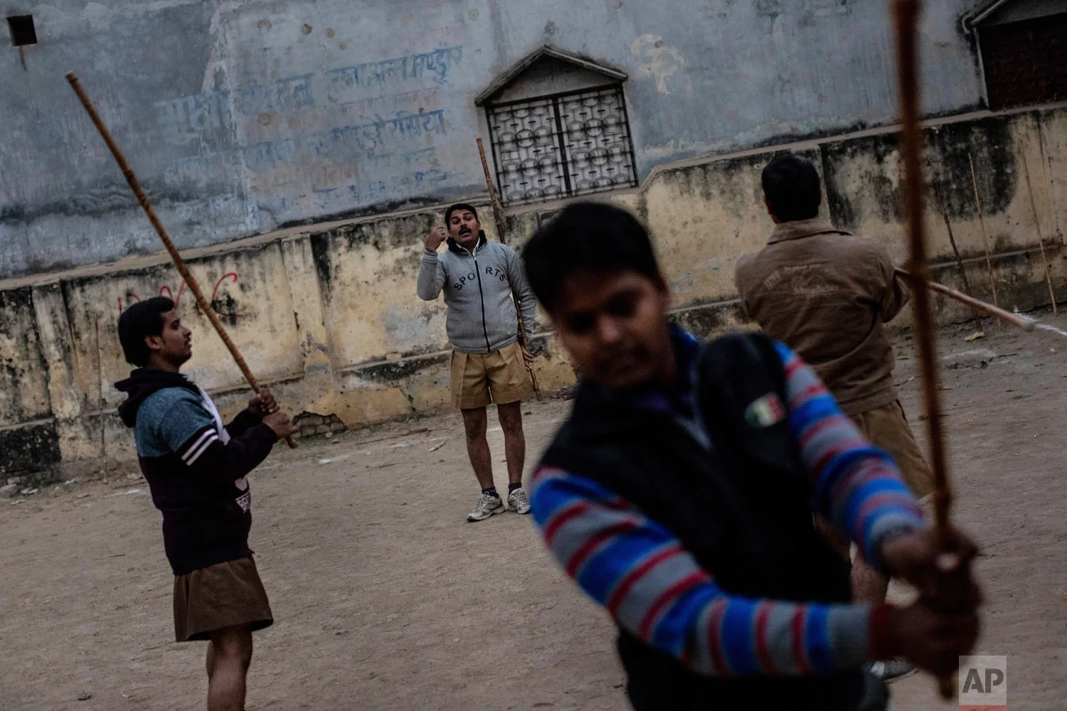Members of the Rashtriya Swayamsevak Sangh (RSS) gather during an early morning shakha, a daily training, in Prayagraj, India on Dec. 11, 2018. (AP Photo/Bernat Armangue)