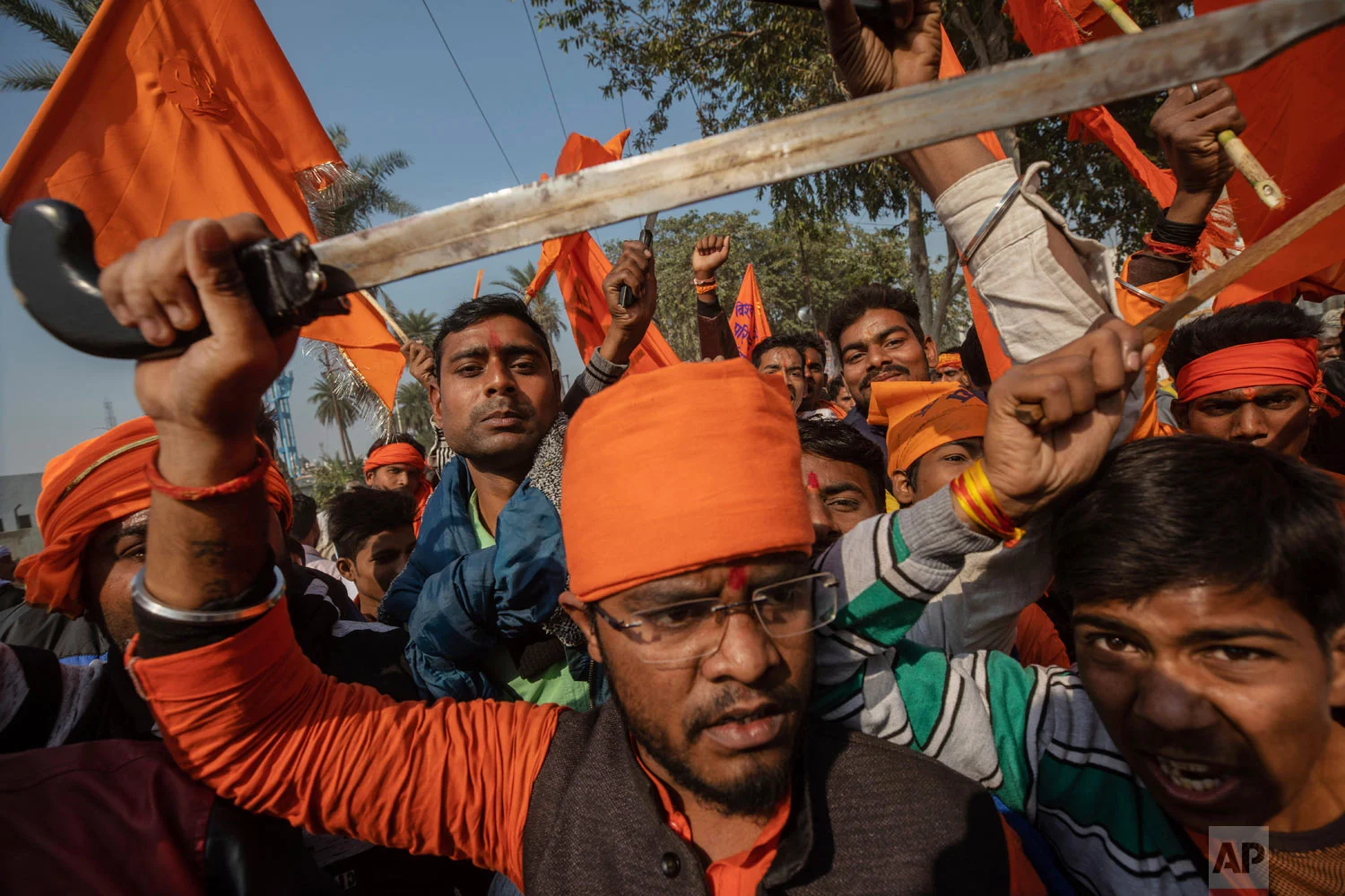 Hindu hardliners, one holding a sword, chant slogans against Muslim communities Nov. 25, 2018, during a rally demanding a Hindu temple be built on a site in northern India where hardliners in 1992 had attacked and demolished a 16th century mosque in Ayodhya Uttar Pradesh. Riots had left about 2,000 people dead. (AP Photo/Bernat Armangue)