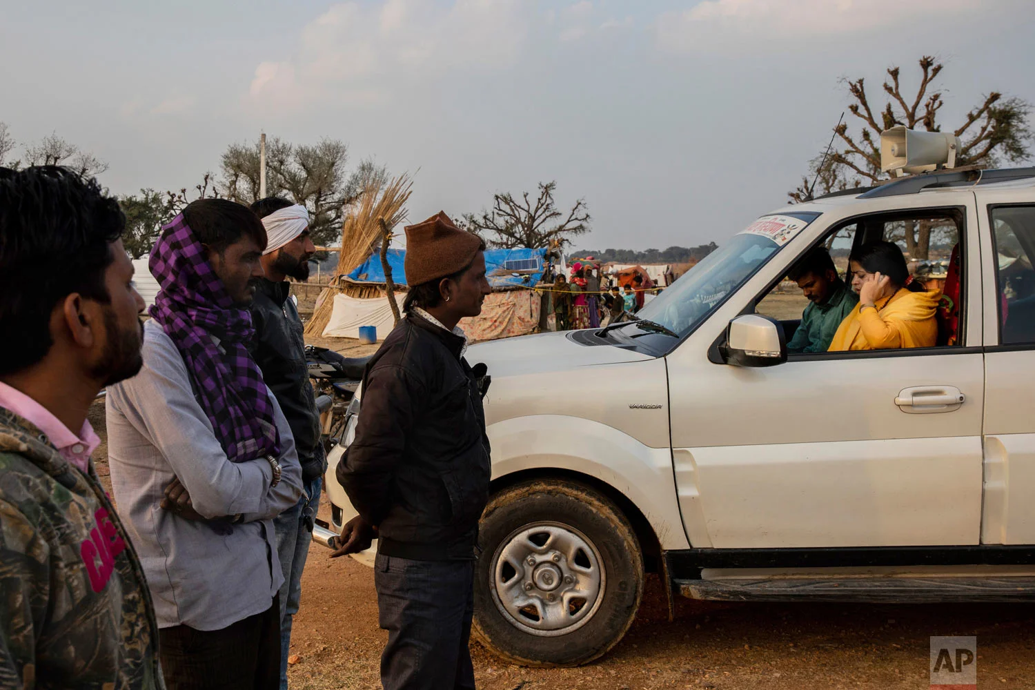 Hindu holy woman Sadhvi Kamal, 40, talks on the phone with members of her vigilante network in front Indian muslim cattle traders on the outskirts of Jaipur, Rajasthan, India, Jan. 25, 2019. (AP Photo/Bernat Armangue)