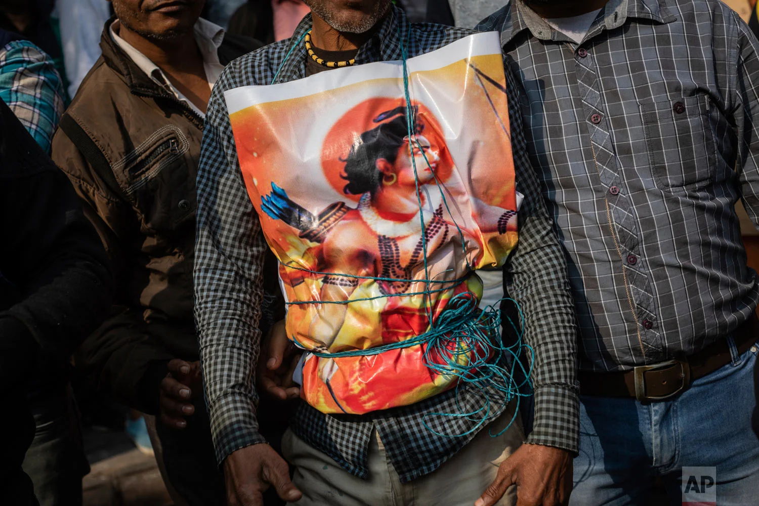 A supporter of Hindu-extreme political group Vishwa Hindu Parishad wears a poster of the Hindu god Ram during a rally in New Delhi, India, Dec. 9, 2018. (AP Photo/Bernat Armangue)