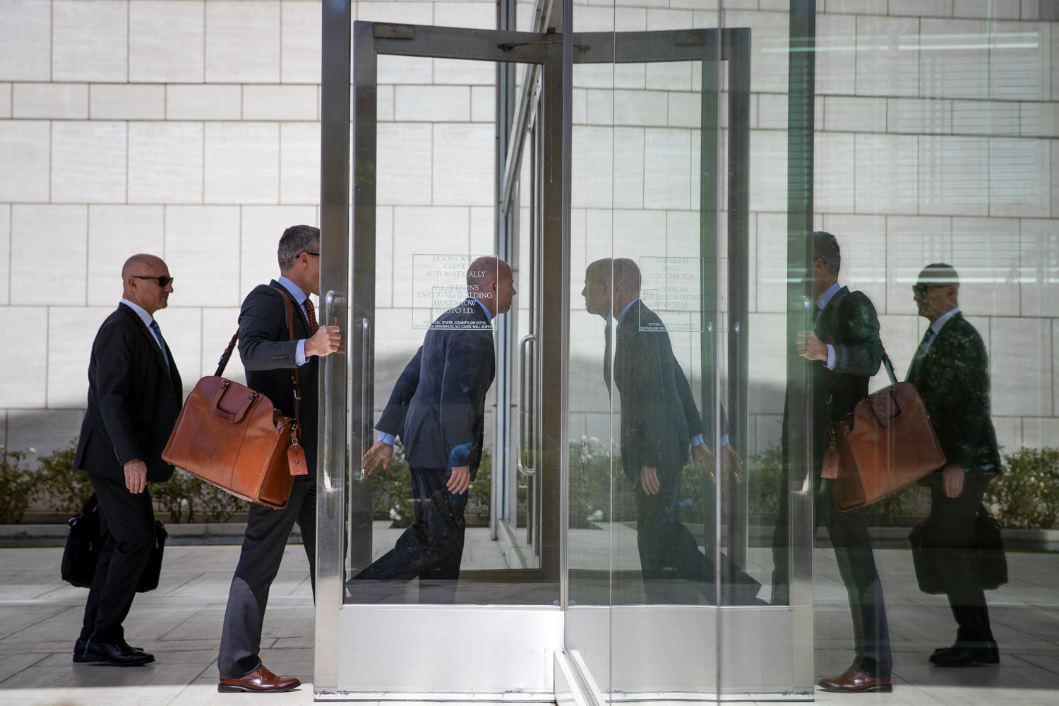 Attorney Michael Avenatti, center, arrives at federal court Monday, April 1, 2019, in Santa Ana, Calif. Avenatti appeared in federal court on charges he fraudulently obtained $4 million in bank loans and pocketed $1.6 million that belonged to a client. (AP Photo/Jae C. Hong)