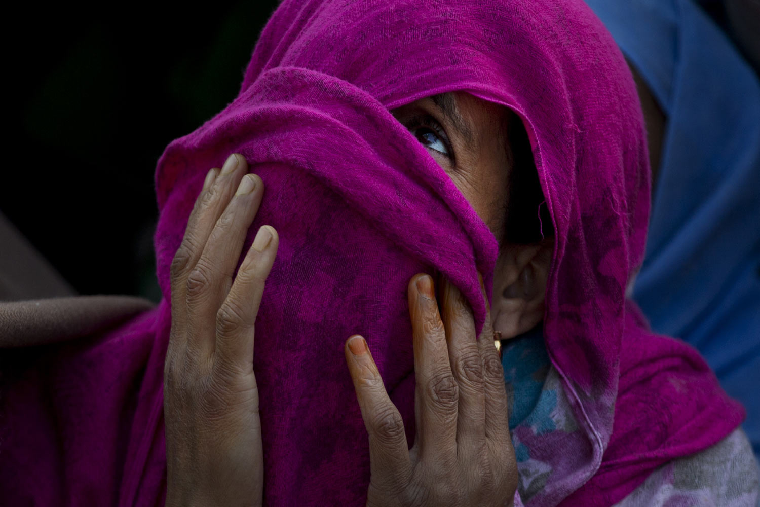 A Kashmiri Muslim woman prays as the head priest displays a relic at the Hazratbal shrine on the occasion of Mehraj-u-Alam, believed to mark the ascension of Prophet Muhammad to heaven, in Srinagar, Indian-controlled Kashmir, on Thursday, April 4, 2019. Thousands of Kashmiri Muslims gathered at the Hazratbal shrine, which houses a relic believed to be a hair from the beard of Islam's Prophet Muhammad. (AP Photo/Dar Yasin)