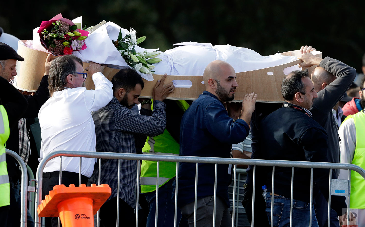  Mourners carry a body at Memorial Park Cemetery in Christchurch, New Zealand, Friday, March 22, 2019. Funerals continued following the March 15 mosque attacks where 50 worshippers were killed by a white supremacist.  (AP Photo/Mark Baker) 