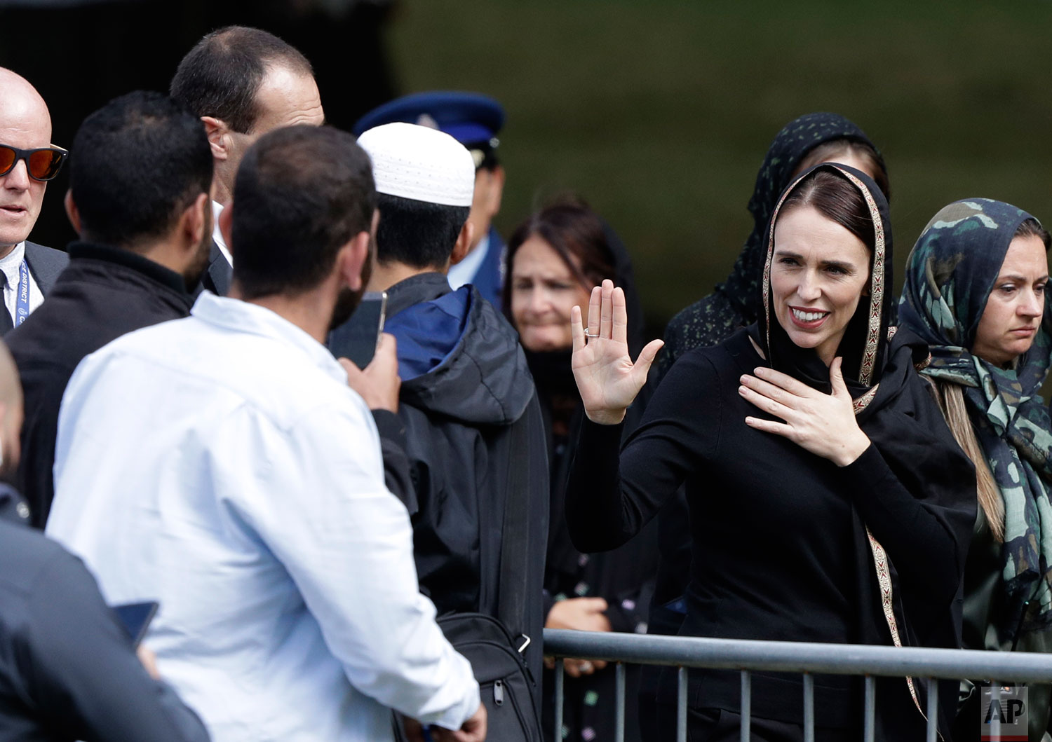 New Zealand Prime Minister Jacinda Ardern waves as she leaves Friday prayers at Hagley Park in Christchurch, New Zealand, Friday, March 22, 2019. Thousands of people gathered in a Christchurch city park near the Al Noor mosque where a gunman killed some of the 50 worshippers in a white supremacist attack on two mosques. (AP Photo/Mark Baker)