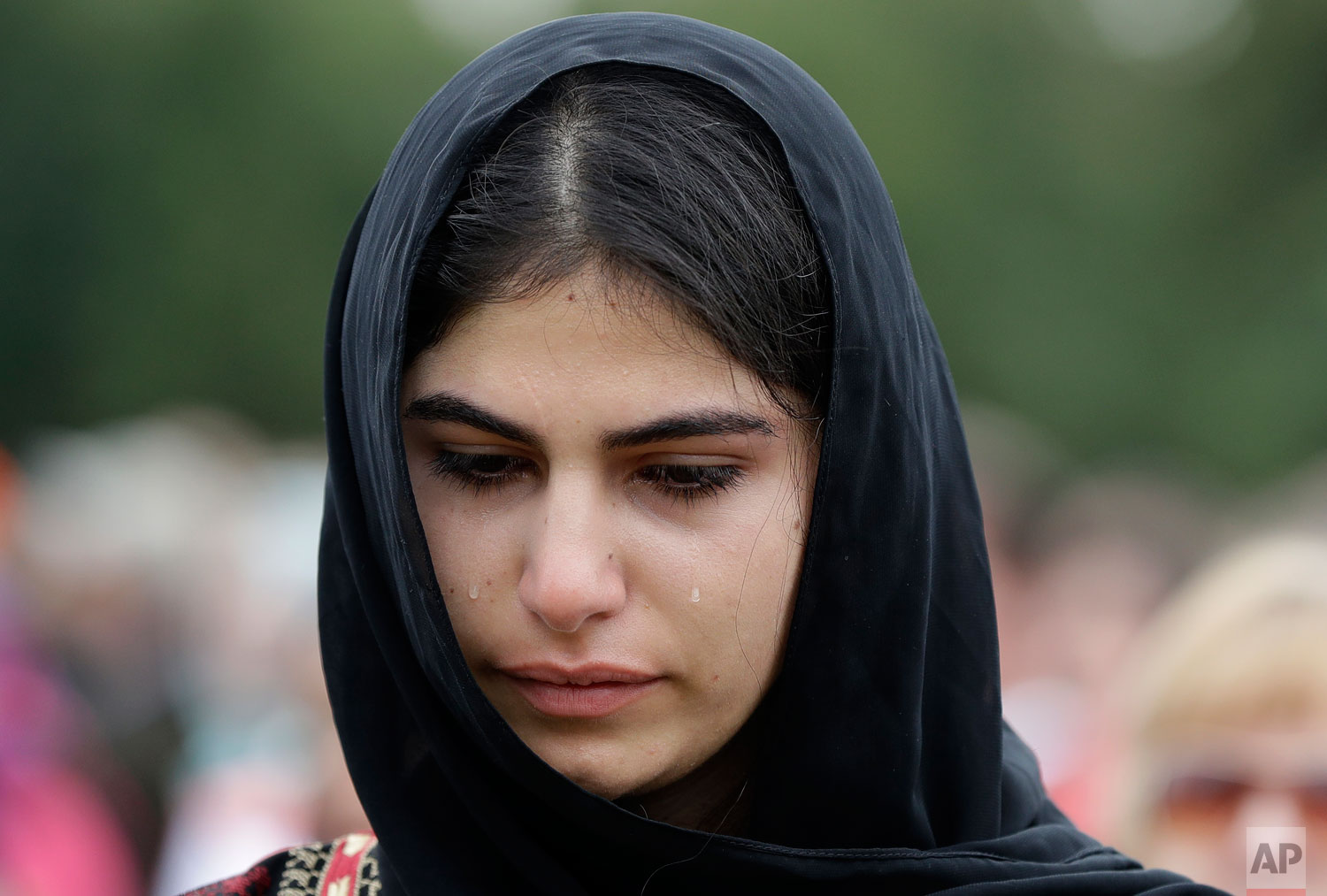  A young muslim woman cries during a gathering for the "March for Love" in Hagley Park following last week's mosque attacks in Christchurch, New Zealand March 23, 2019.   (AP Photo/Mark Baker) 