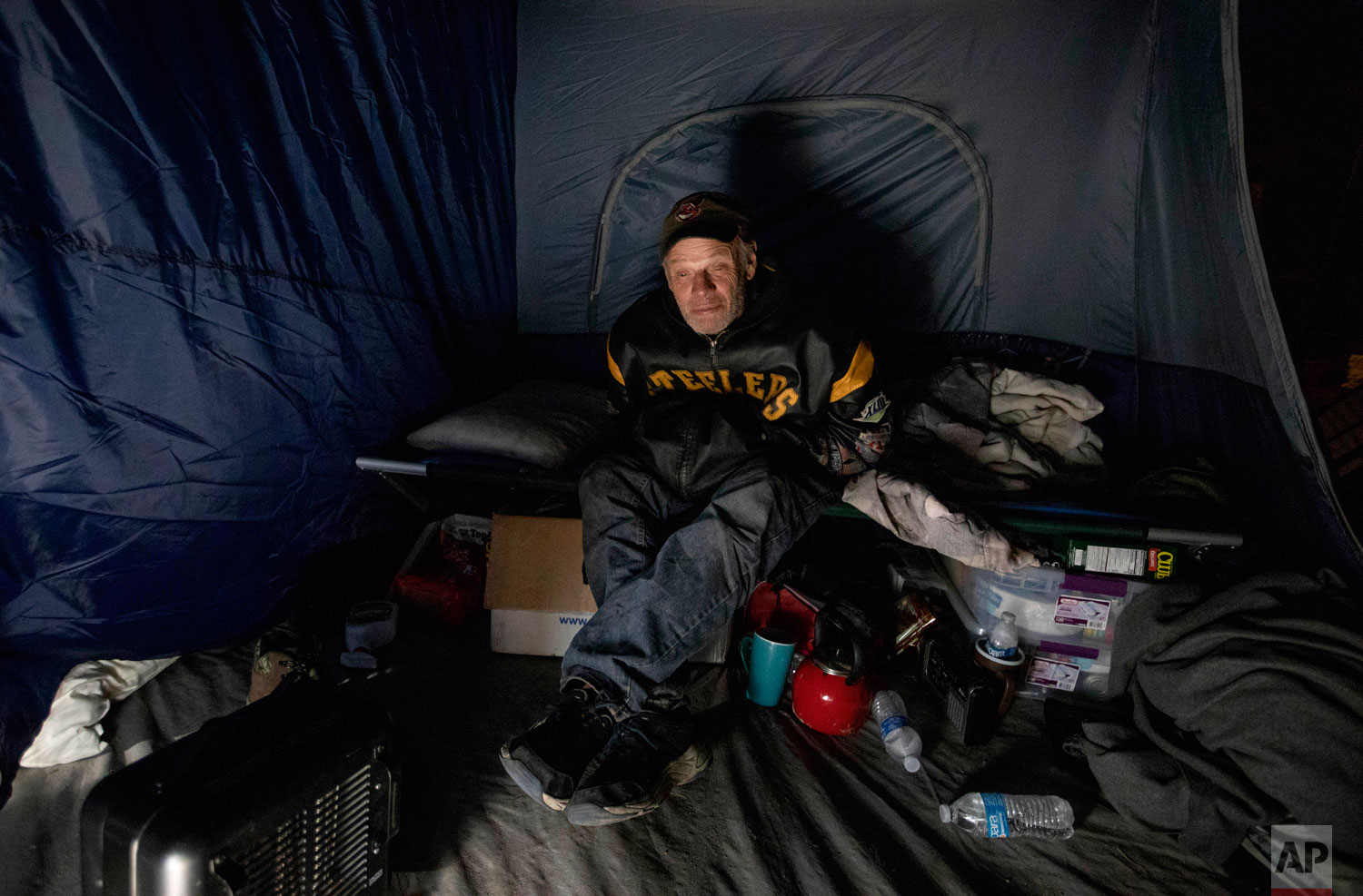  James Huebner sits in his tent in the backyard of a home where he's living with his son and brother after becoming homeless from Hurricane Michael in Youngstown, Fla, Wednesday, Jan. 23, 2019. Huebner has never been homeless before and says they can