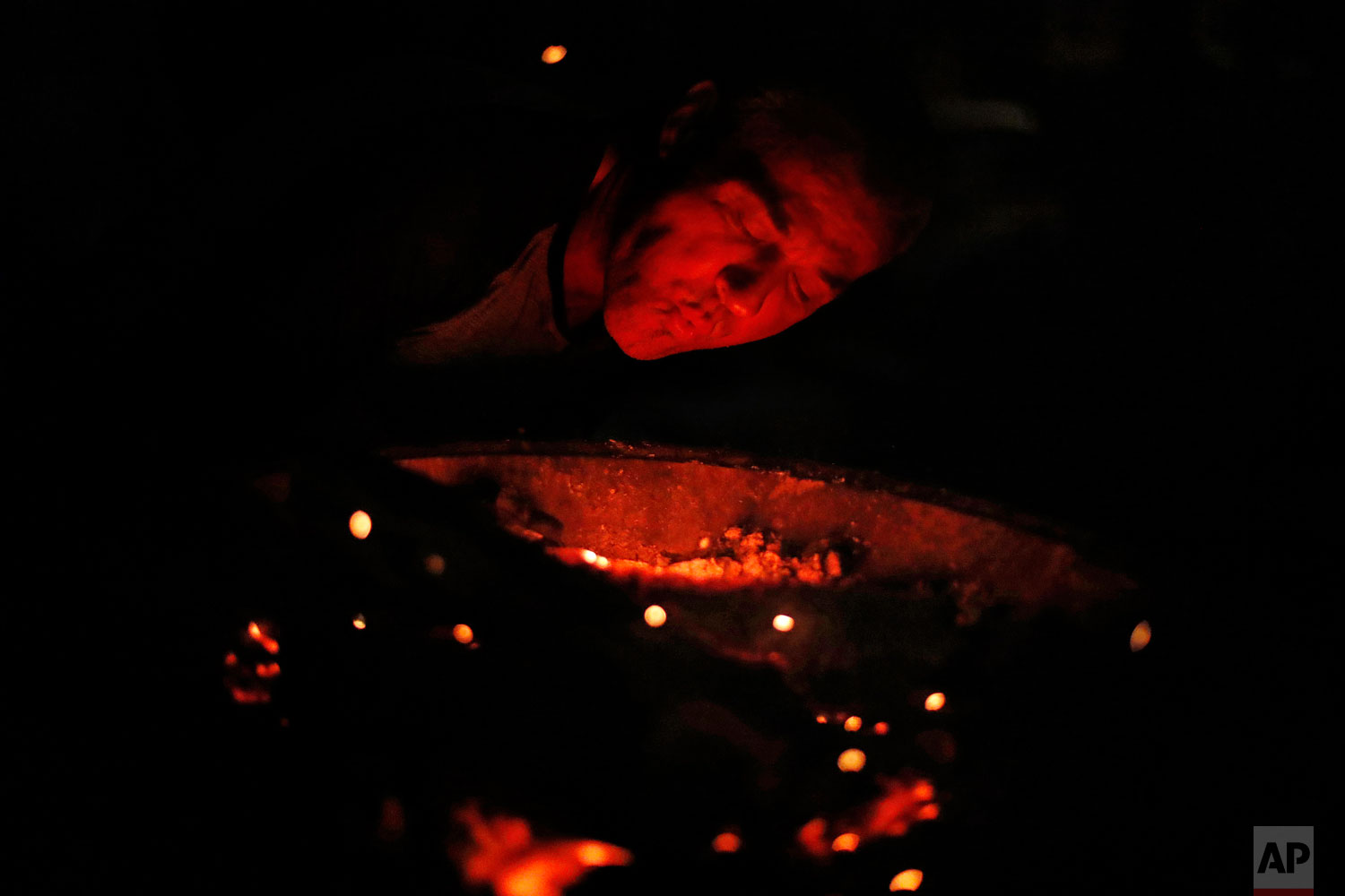  Gene Hogan blows on a campfire outside the tent he's living in since becoming homeless from Hurricane Michael in Youngstown, Fla, Wednesday, Jan. 23, 2019. Hotel vouchers and trailers provided by the Federal Emergency Management Agency are helping e