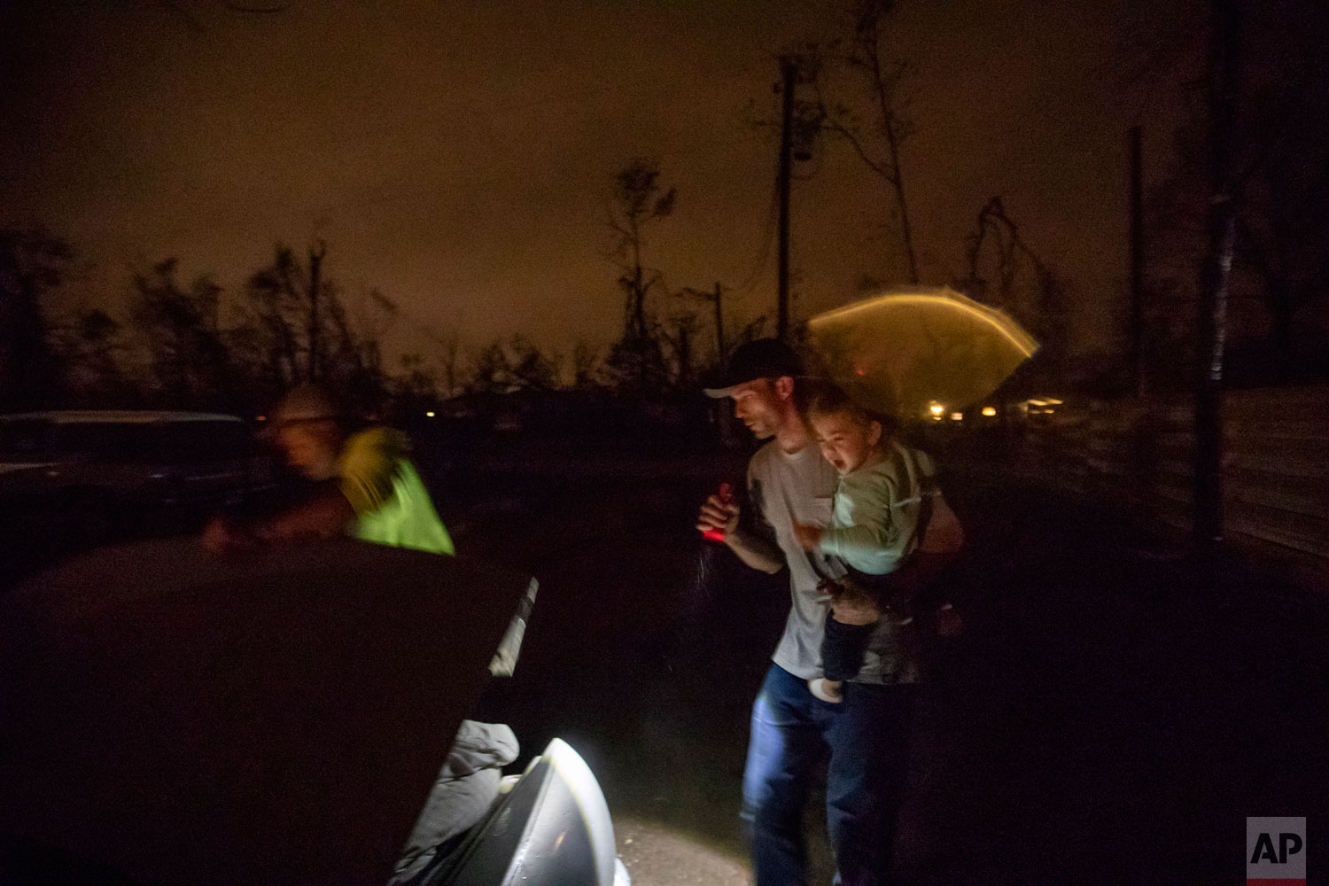  Twenty-month-old Neala Clark cries as her mother's fiancé, Gary LaPlant, loads their personal belongings from the tent they're living in into a car taking them to a halfway home LaPlant found for them in the middle of a rain storm in Youngstown, Fla