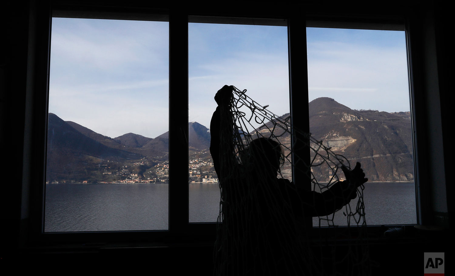  In this photo taken on Wednesday, Feb. 6, 2019, a woman works at "La Rete" (The Net) factory in Monte Isola, Lake Iseo, northern Italy. Step off the ferry onto Monte Isola and it feels like going back in time. The factory of La Rete S.r.l. _ an old-