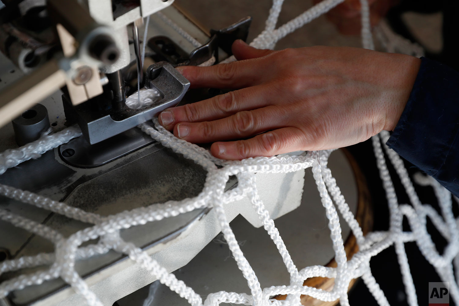  In this photo taken on Wednesday, Feb. 6, 2019, a woman works at "La Rete" (The Net) factory in Monte Isola, Lake Iseo, northern Italy.  (AP Photo/Antonio Calanni) 