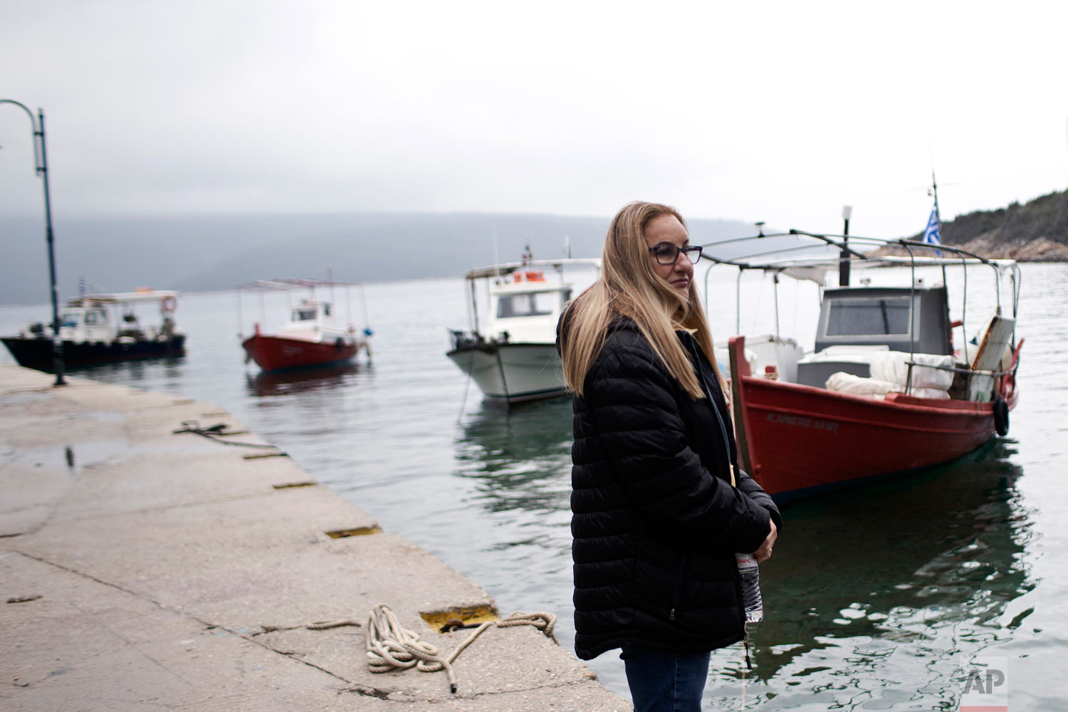 Archaeologist Elpida Hadjidaki stands at the harbor of Steni Vala, with Peristera island seen in the background, in Greece, April 7, 2019. (AP Photo/Petros Giannakouris)