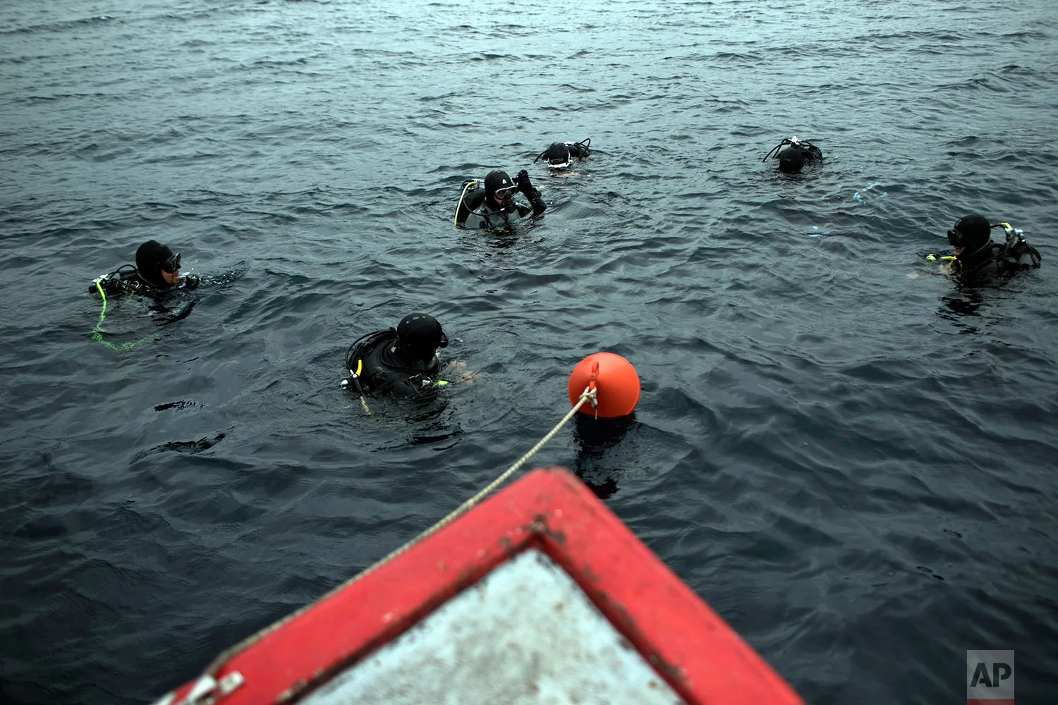 Archeologists and visitors prepare to dive to a 5th Century B.C. shipwreck near the coast of Peristera, Greece, April 7, 2019. (AP Photo/Petros Giannakouris)