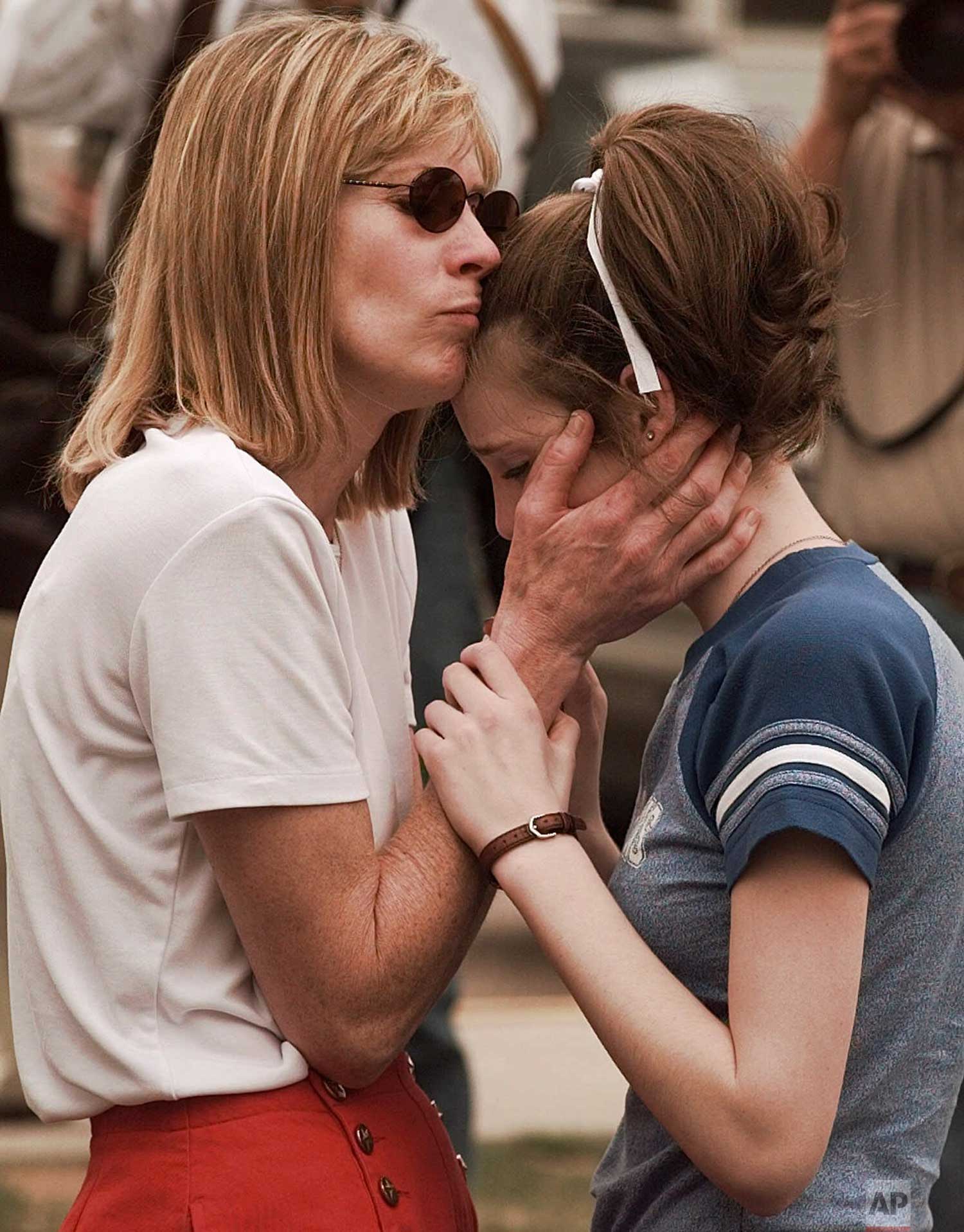  Kate Moulton, left, is reunited with her daughter Lauren, 14, after a shooting at Columbine High School in Denver on Tuesday, April, 20, 1999. Two young men dressed in long, black trench coats opened fire in the suburban high school, scattering stud