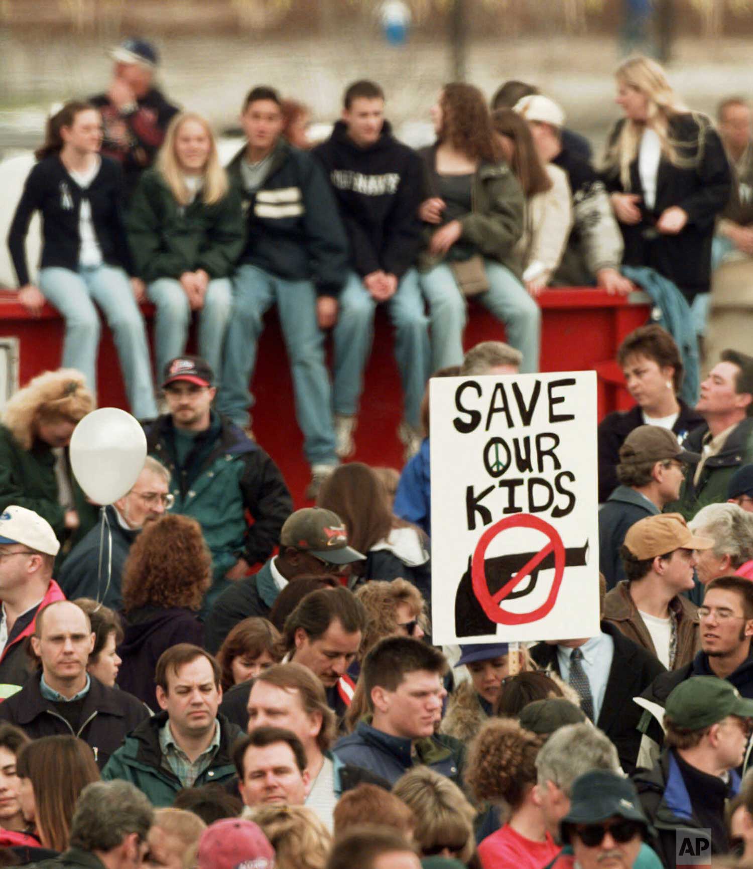  A participant at a memorial service for the victims of the Columbine High School shooting rampage holds a "NO GUNS" sign in Littleton, Colo., on Sunday, April 25, 1999.  (AP Photo/Eric Gay) 