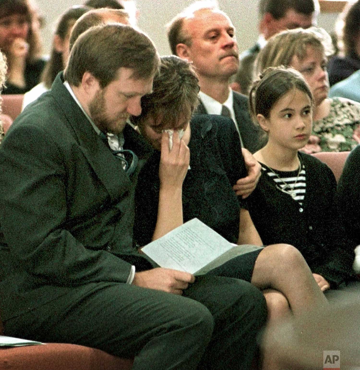  John Tomlin consoles his wife Doreen while their daughter Ashley watches the funeral of John Robert Tomlin at the Community United Methodist Church in Waterford, Wis., Wednesday, April 28, 1999. Tomlin was killed in the library at Columbine High Sch