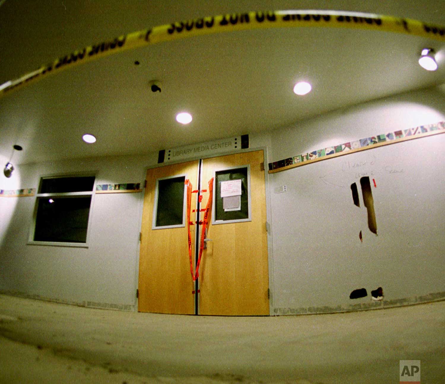  Tape marks the line in front of the doors to the library in Columbine High School as members of the media took their first trip through the school in the southwest Denver suburb of Littleton, Colo., Tuesday, June 15, 1999, since it was the scene of 