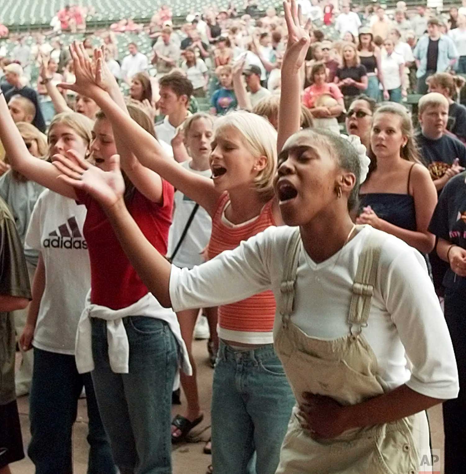  Students sing their praise to God during a youth inspirational rally "Columbine and Friends," at Fiddler's Green Amphitheater in Englewood, Colo., Saturday night, August 14, 1999, in the wake of the Columbine High School shooting. (AP Photo/Ed Andri
