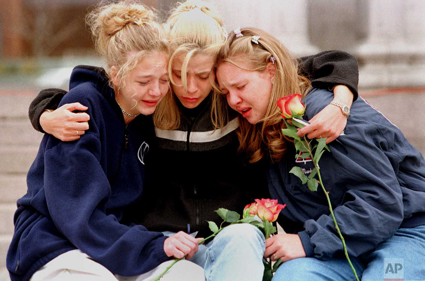  From left, Rachel Ruth, Rhianna Cheek and Mandi Annibel, all 16-year-old sophomores at Heritage High School in Littleton, Colo., console each other during a vigil service in Denver's Civic Center Park late Wednesday, April 21, 1999, to honor the vic