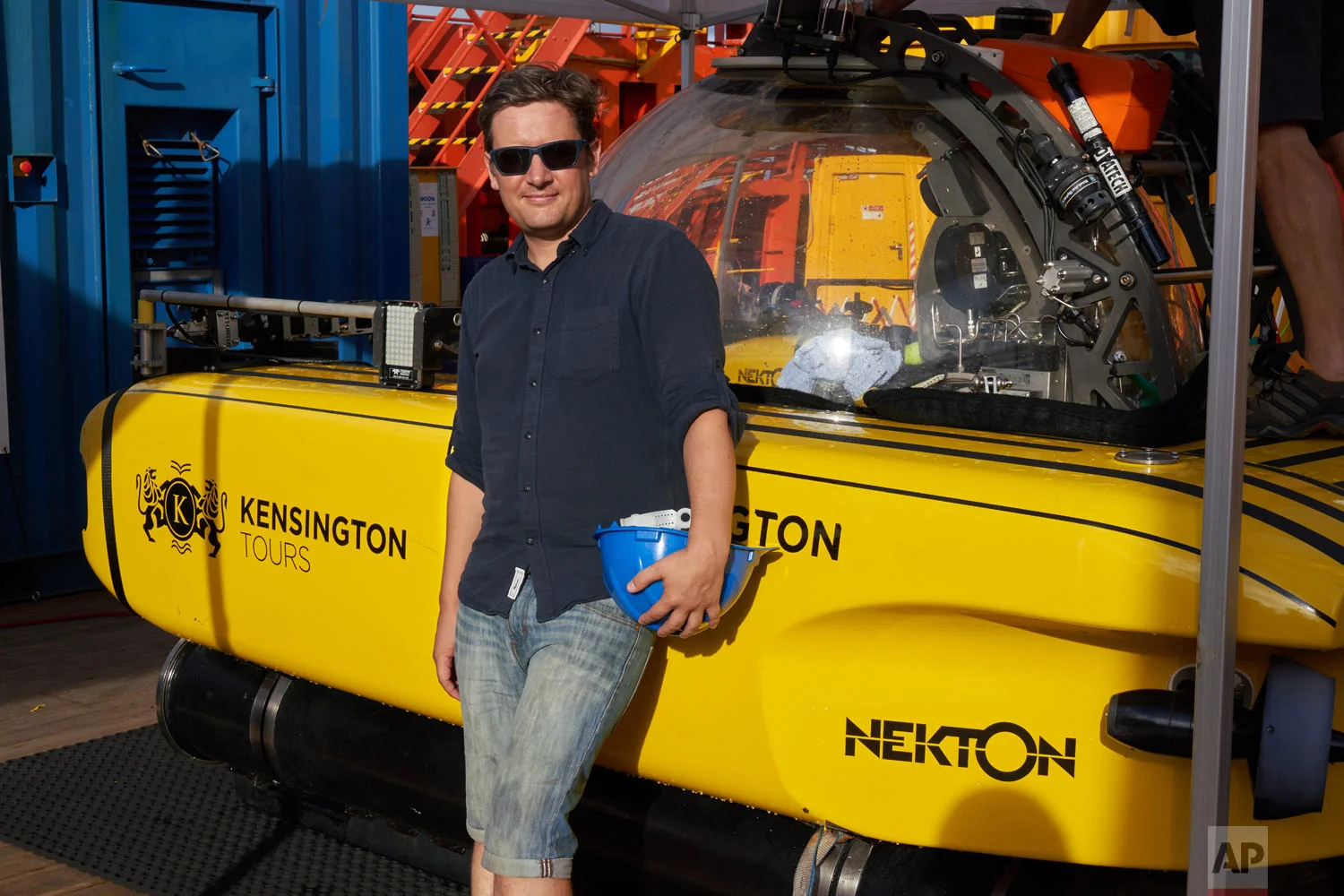 AP Reporter David Keyton stands next to the submersible which took him 400 feet below the surface of the Indian Ocean off the island of St. Joseph, April 8, 2019. (AP Photo/Toby Goode)