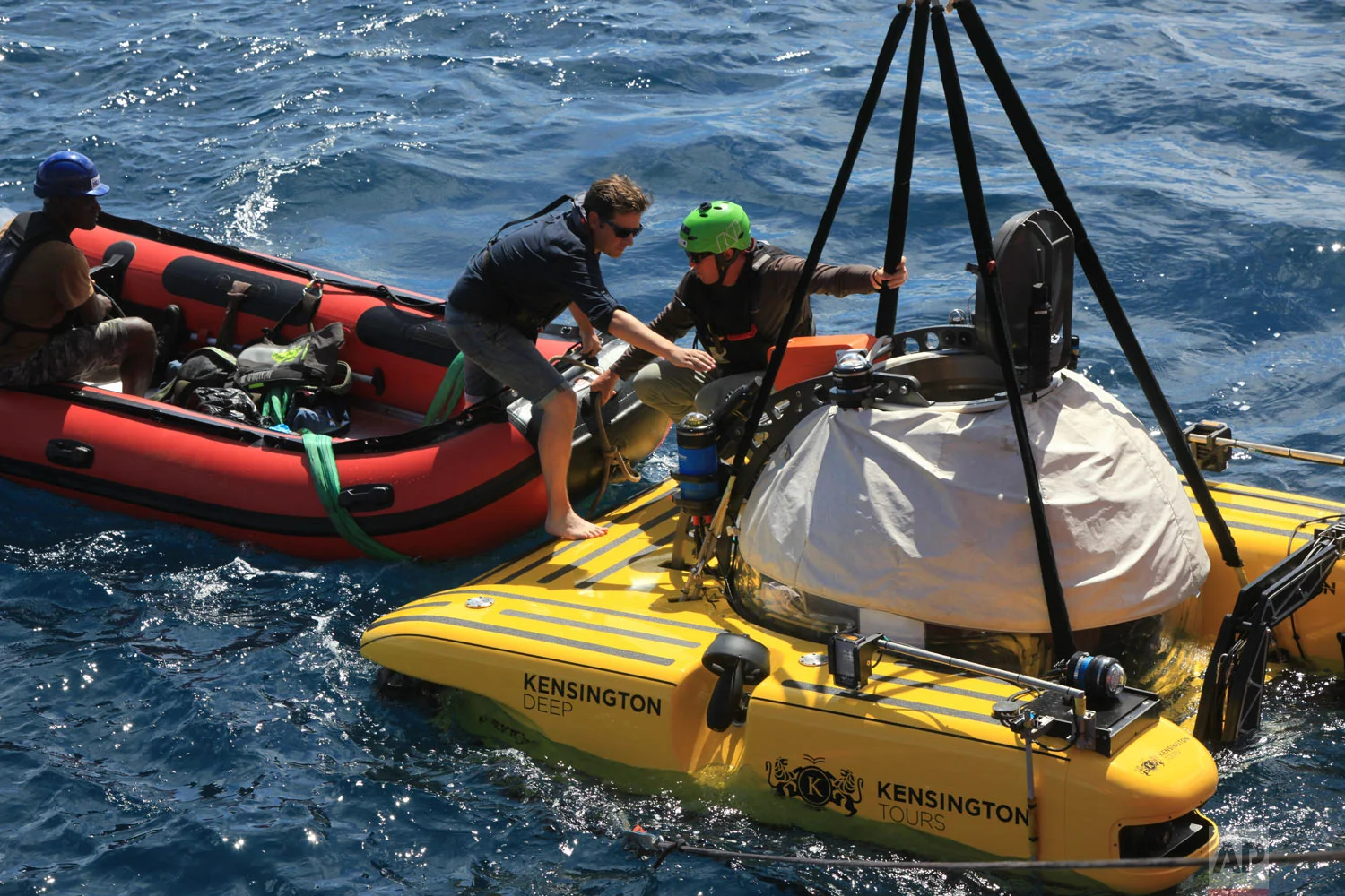 AP reporter, David Keyton, boards a submersible off the coast of the island of St. Joseph in the Seychelles, April 8, 2019. (AP Photo/Steve Barker)