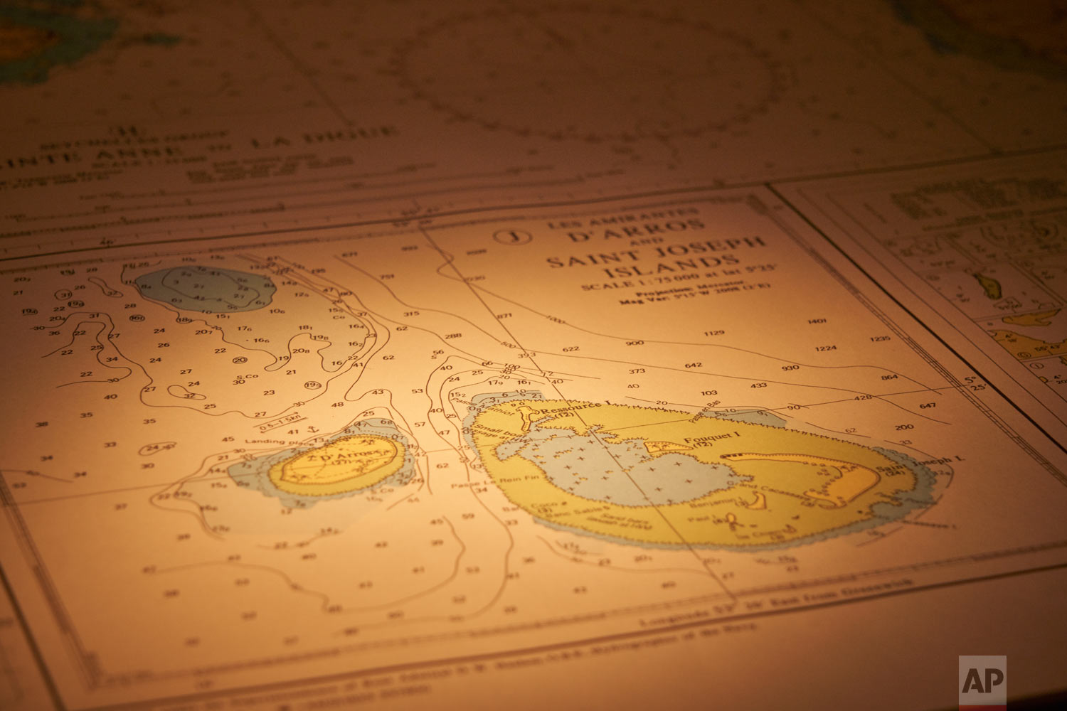 A nautical chart shows the waters around the island of Saint Joseph in the Seychelles lays open on the bridge of the Ocean Zephyr, April 11, 2019. (AP Photo/David Keyton)