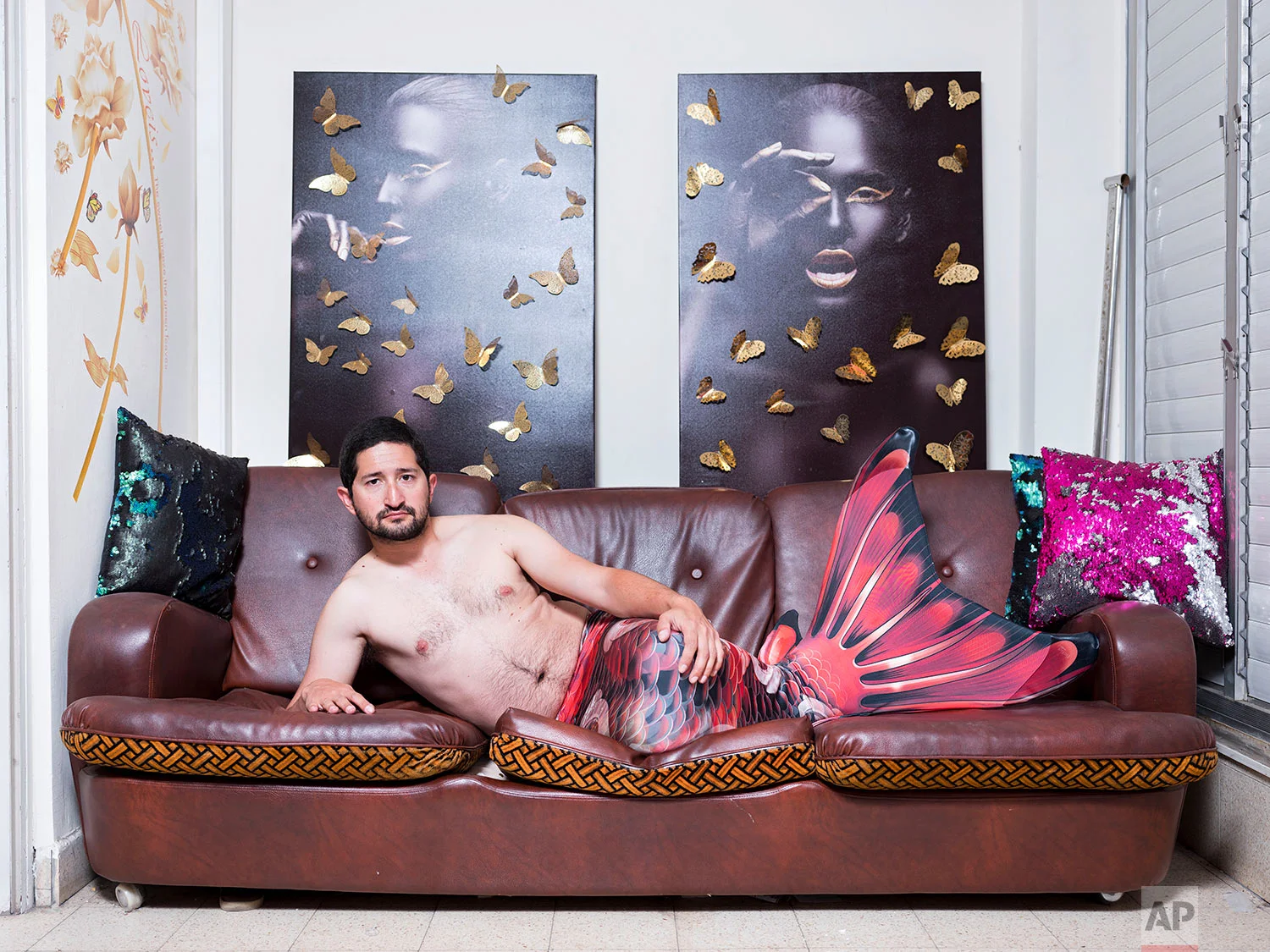 In this Thursday, Feb. 28, 2019 photo, Gal Amnony, a member of the Israeli Mermaid Community, poses for a portrait as he wears a mermaid tail at his home in Ramat Gan, Israel. (AP Photo/Oded Balilty)