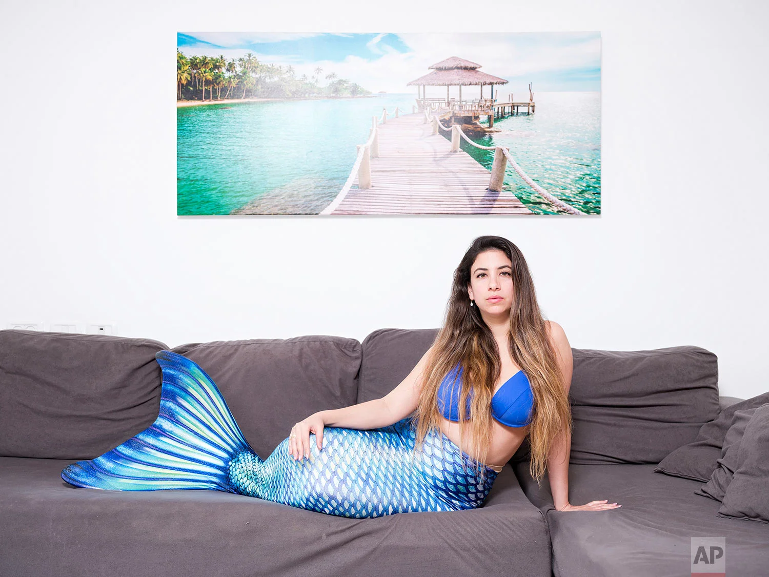 In this Monday, March. 4, 2019 photo, Ligal Shternhell, a member of the Israeli Mermaid Community, poses for a portrait as she wears a mermaid tail at her home in Kibbutz Ein Carmel, Israel. (AP Photo/Oded Balilty)