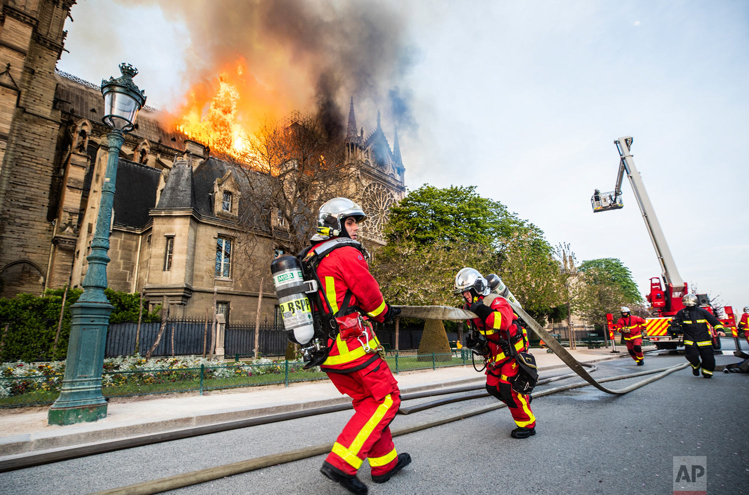 In this photo provided by the Paris Fire Brigade, firefighters work at the burning Notre Dame Cathedral, April 15, 2019. (Benoit Moser, BSPP via AP)