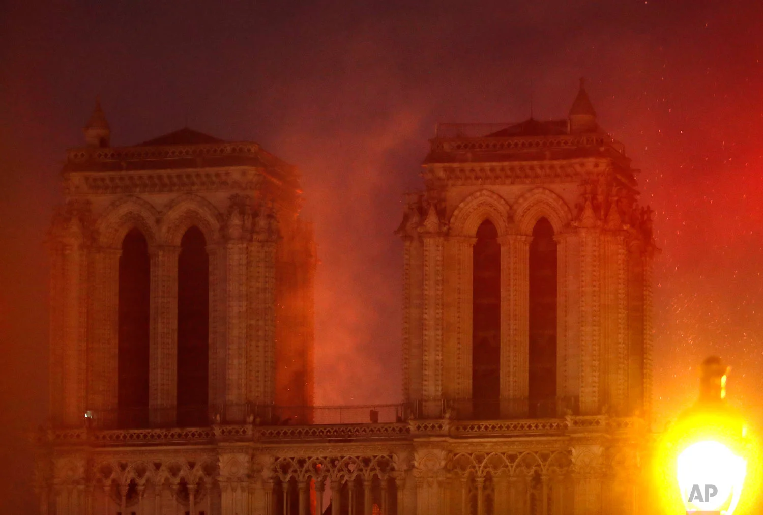 Flames illuminate the night sky as Notre Dame Cathedral burns in Paris, April 15, 2019. (AP Photo/Thibault Camus)