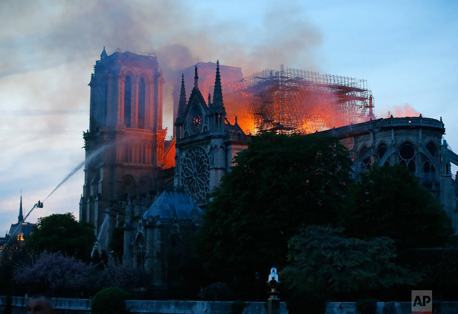 Firefighters tackle the blaze as flames and smoke rise from Notre Dame Cathedral as it burns in Paris, April 15, 2019. (AP Photo/Thibault Camus)