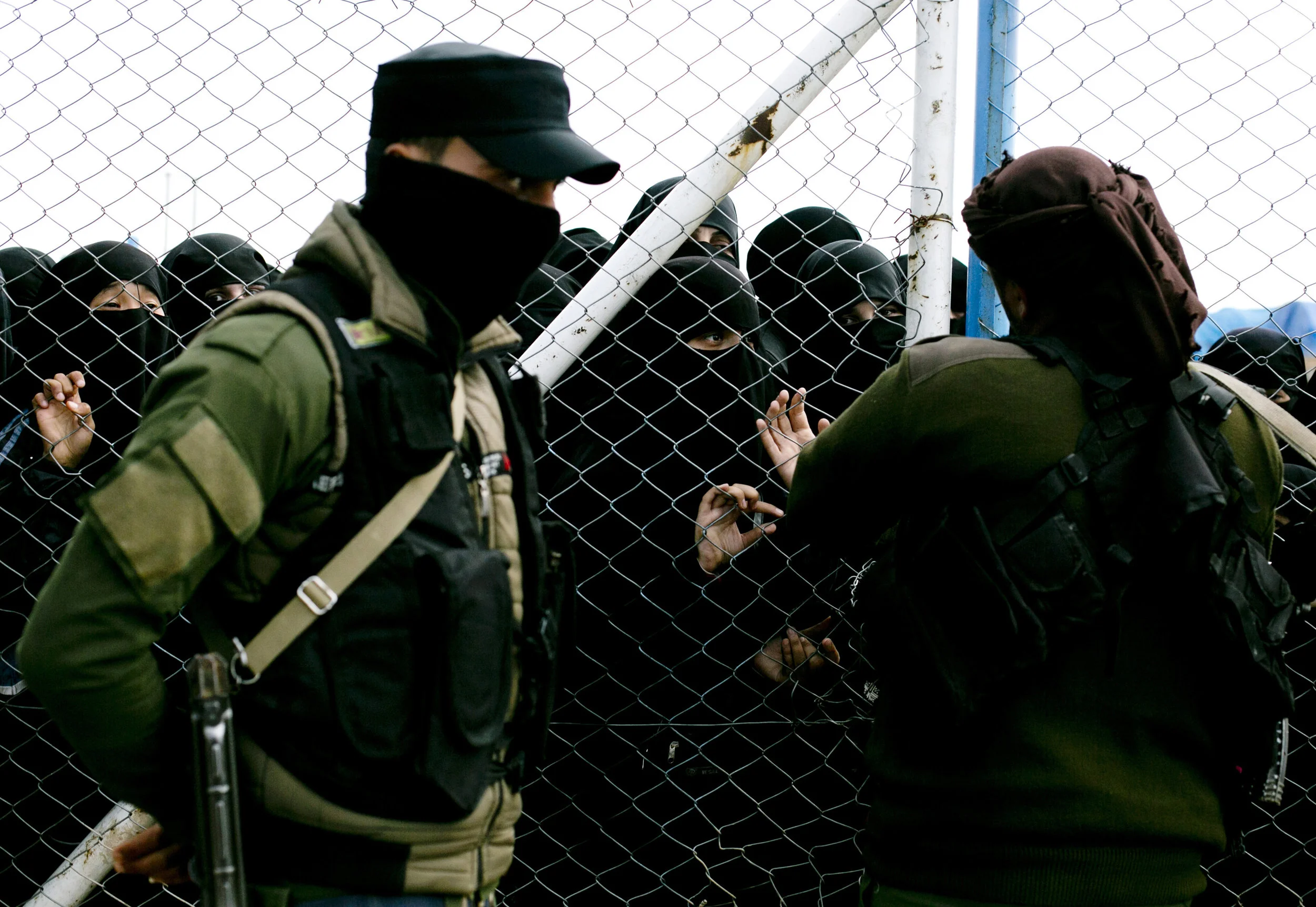Women speak to guards at the gate that closes off the section for foreign families who lived in the Islamic State's so-called caliphate, at al-Hol camp in Hassakeh province, Syria on March 31, 2019. (AP Photo/Maya Alleruzzo)