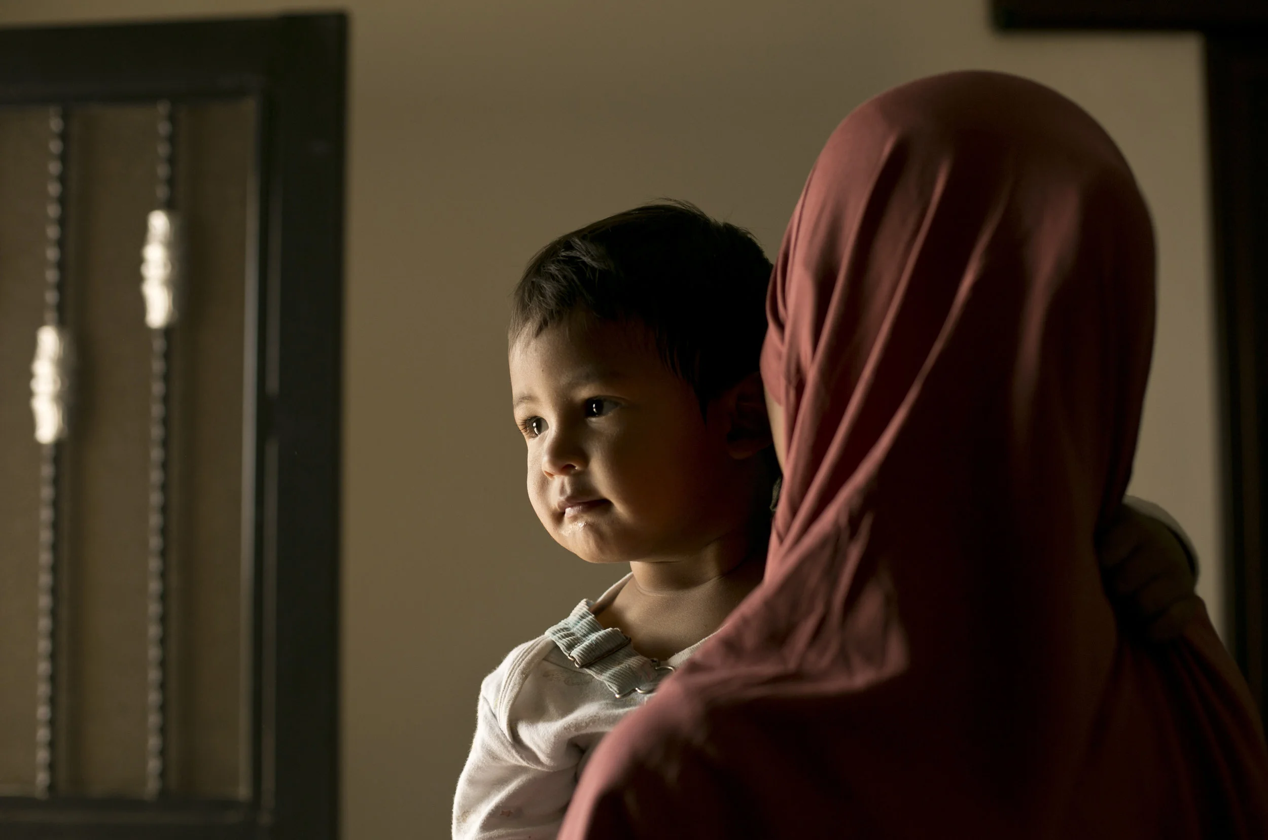 Aliya, a 20 year-old Indonesian national, poses for a portrait with her son, Yahya, at Camp Roj in north Syria on March 26, 2019. (AP Photo/Maya Alleruzzo)