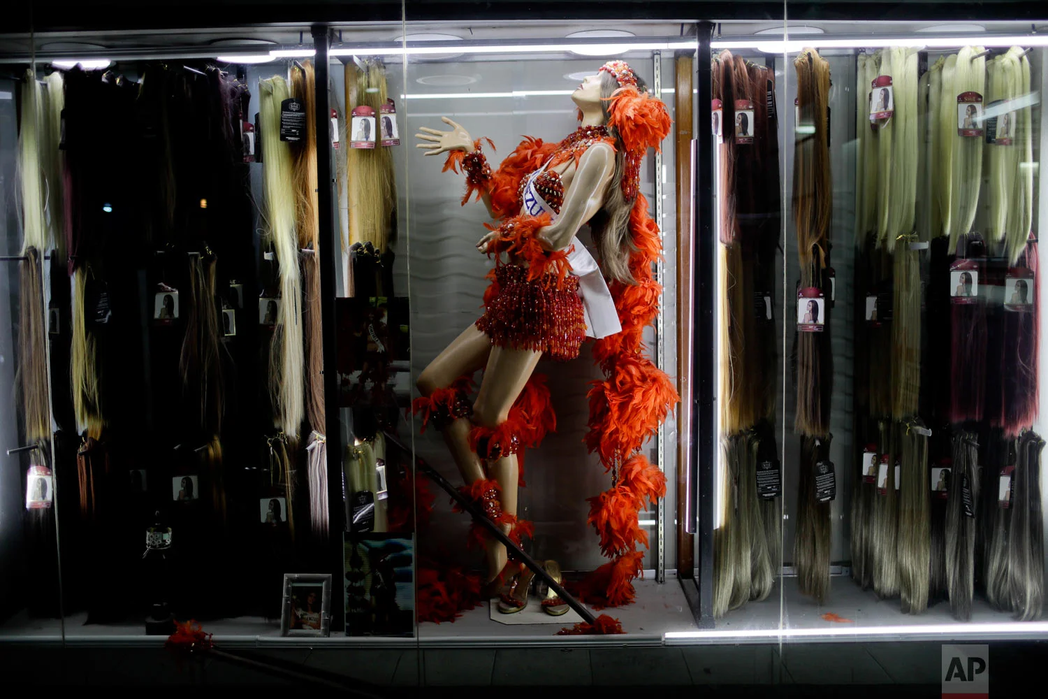  A mannequin dressed as Miss Venezuela is surrounded by hair extensions at a beauty salon in Caracas, Venezuela, Friday, March 22, 2019. (AP Photo/Natacha Pisarenko) 