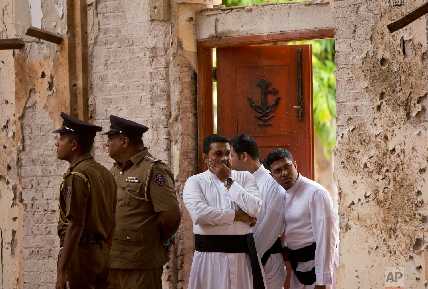 Clergymen visit the scene of a suicide bombing at St. Sebastian Church in Negombo, Sri Lanka, April 22, 2019. (AP Photo/Gemunu Amarasinghe)