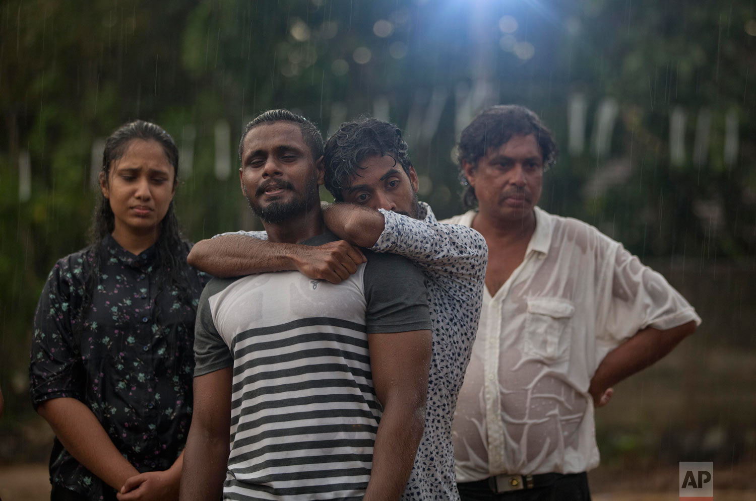 Mourners grieve at the burial of three members of the same family victims of Easter Sunday bomb blast at St. Sebastian Church in Negombo, Sri Lanka, April 22, 2019. (AP Photo/Gemunu Amarasinghe)