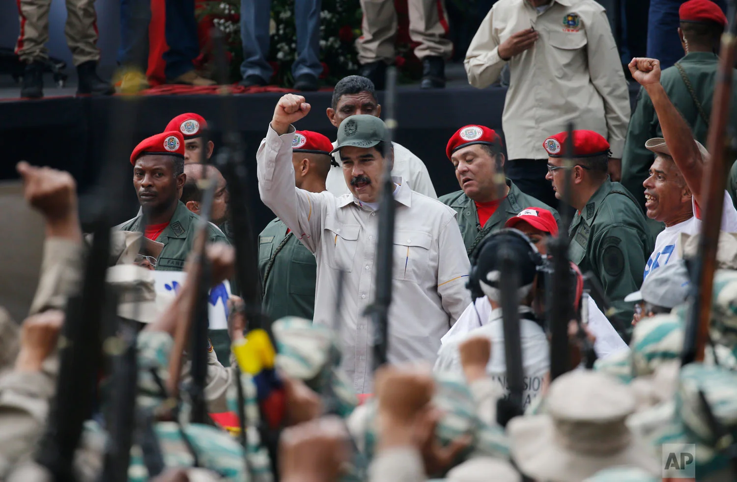 Venezuela's President Nicolas Maduro cheers the Bolivarian Militia during their 10th anniversary celebration in Caracas, Venezuela, Saturday, April 13, 2019. Officially known as the Venezuelan National Bolivarian Militia, it is a branch of the National Armed Forces of Venezuela created by the late President Hugo Chavez and today it is made up of over 2 million men and women. (AP Photo/Ariana Cubillos)