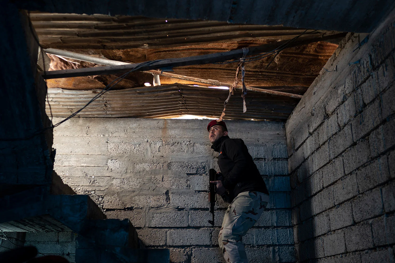 In this April 5, 2019 photo, an Iraqi army 20th division soldier searches a house during a raid in Badoush, Iraq.(AP Photo/Felipe Dana)