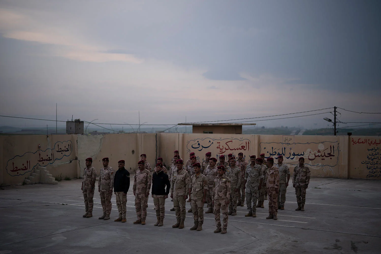 In this April 10, 2019 photo, Iraqi army 20th division soldiers stand in formation in a military base in Badoush, Iraq. (AP Photo/Felipe Dana)