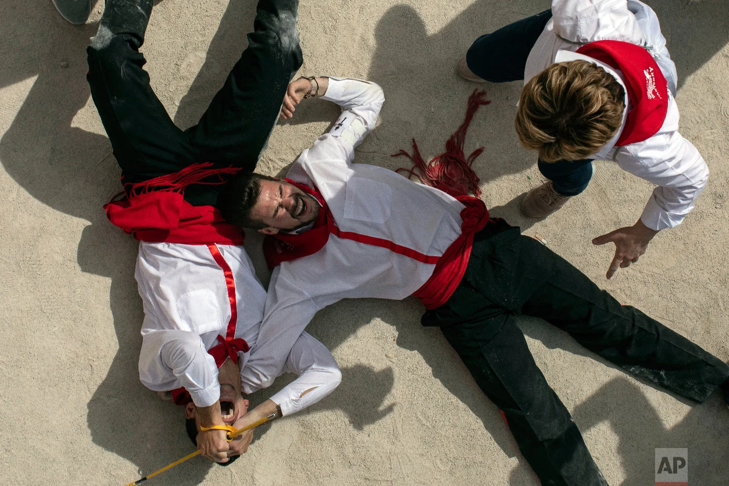 A troupe falls celebrates their timing race during the "Los Caballos del Vino," usually translated as the Running of the Wine Horses in Caravaca de la Cruz, southeast Spain, Thursday, May 2, 2019. (AP Photo/Bernat Armangue)