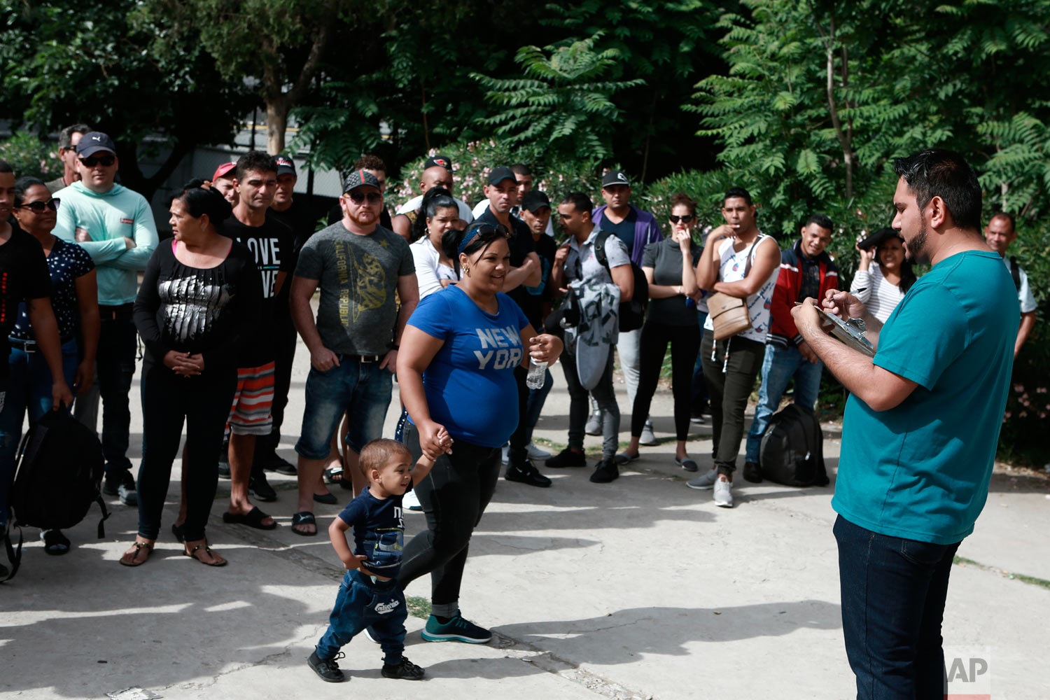 Cuban migrants are registered by Mexican immigration officials in Ciudad Juarez, Mexico, April 29, 2019, to be taken across the Paso del Norte International bridge to be processed as asylum seekers. (AP Photo/Christian Torres)
