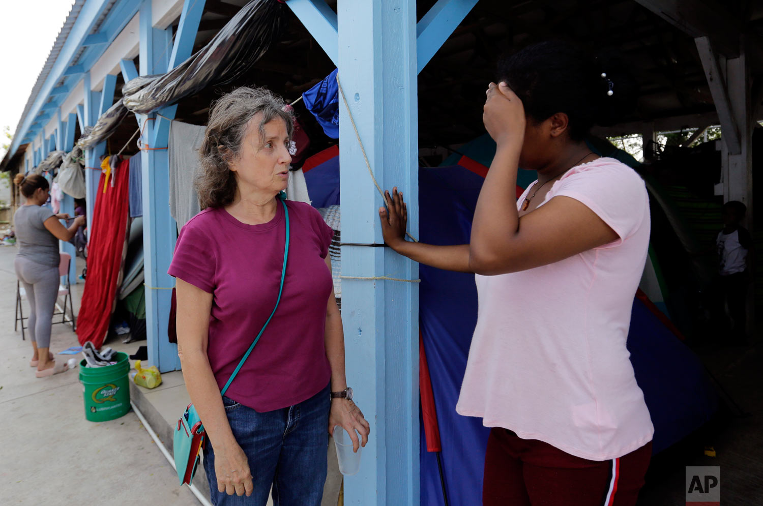 Jennifer Harbury, left, a human rights lawyer, speaks to an asylum seeker in Reynosa, Mexico, May 1, 2019. (AP Photo/Eric Gay)