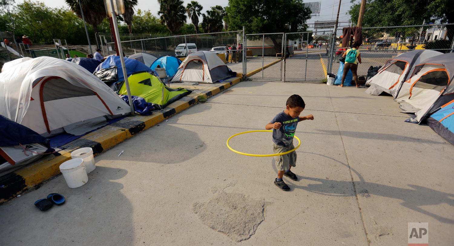 William Linares, 5, who is traveling with his mother Suanny Gomez from Honduras and seeking asylum in the United States plays in an encampment where he is living near the international bridge in Matamoros, Mexico, April 30, 2019. (AP Photo/Eric Gay)