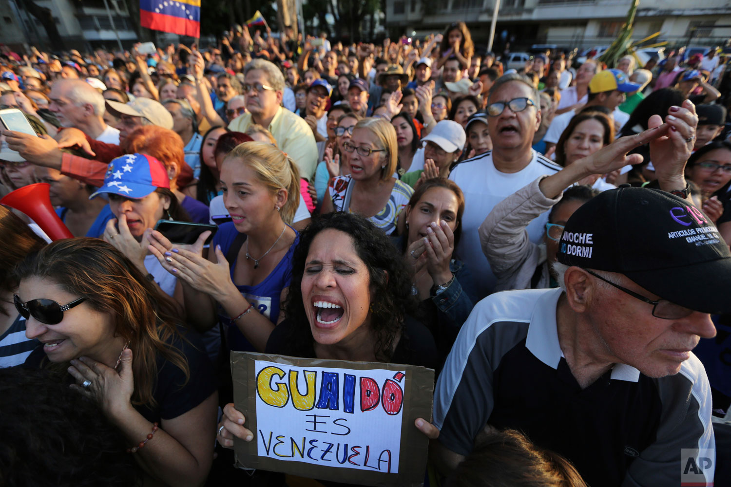 Supporters of self-proclaimed interim president Juan Guaido cheer during a rally in Caracas, Venezuela, Friday, April 5, 2019. (AP Photo/Fernando Llano)