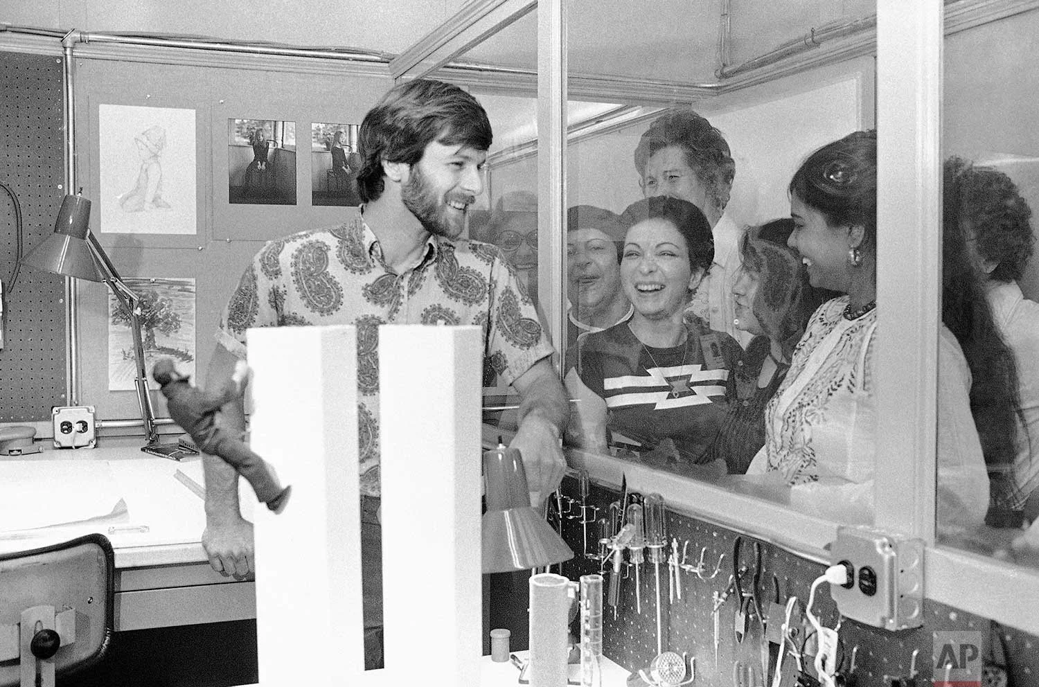 George Willig, the human fly who scaled the World Trade Center towers in Manhattan, poses with a model of the Twin Towers with a GI Joe clinging to the side, at the toy factory in Queens where he works, June 1, 1977. (AP Photo/Ron Frehm)