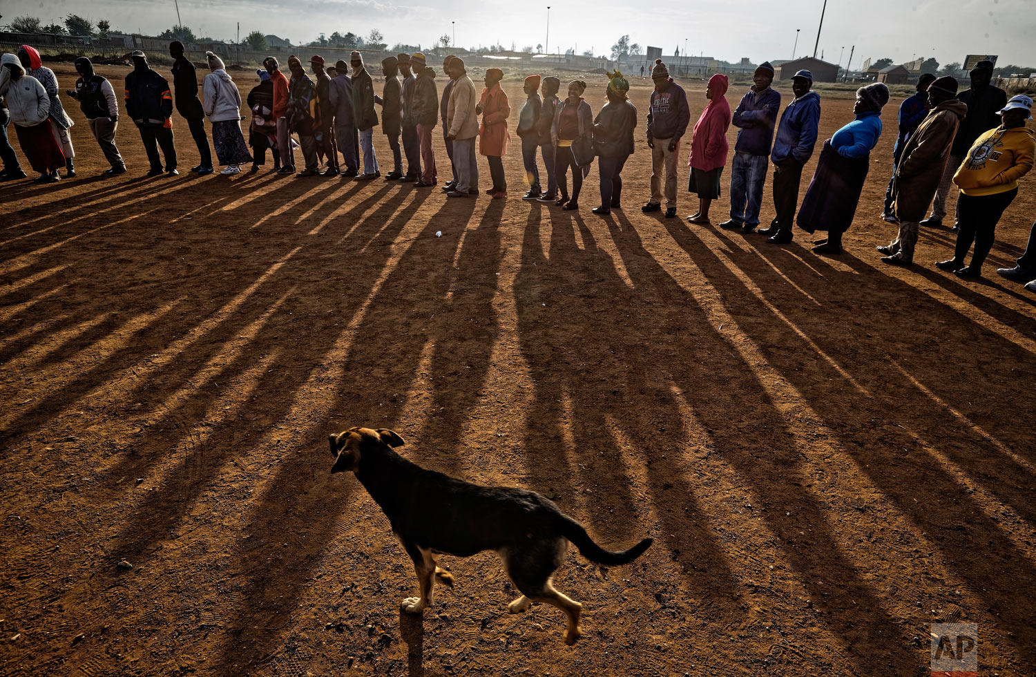 South Africans queue in the early morning sun to cast their votes in the mining settlement of Bekkersdal, west of Johannesburg, in South Africa, May 8, 2019. (AP Photo/Ben Curtis)